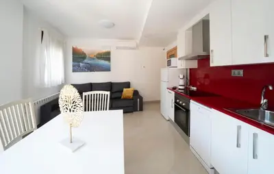 a kitchen and a living room with a couch at Kisa Apartments de Manresa in Manresa