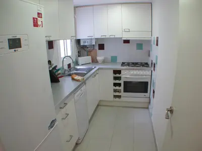 a small kitchen with white cabinets and a sink at Barcelona4Seasons - Gavina in Barcelona
