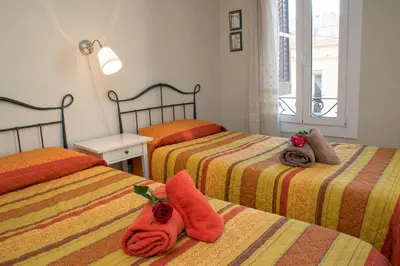 a bedroom with two beds with towels on them at Barcelona4Seasons - Gavina in Barcelona