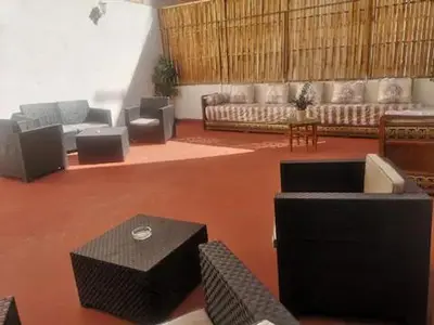 a large living room with couches and a table at Apartahotel Casa Batito in Hospitalet de Llobregat