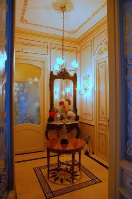 a room with a table with flowers on it at Sitges Royal Rooms in Sitges