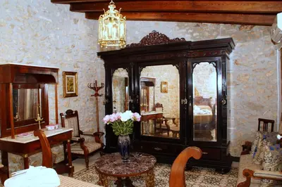a room with a largeoire with a vase of flowers on a table at Sitges Royal Rooms in Sitges