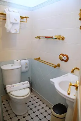 a bathroom with a toilet and a sink at Sitges Royal Rooms in Sitges