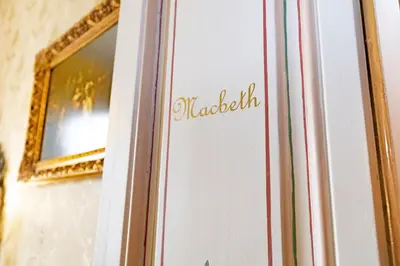 a sign on a door with a mirror at Sitges Royal Rooms in Sitges