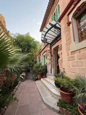 a building with potted plants on the side of it at Sitges Royal Rooms in Sitges