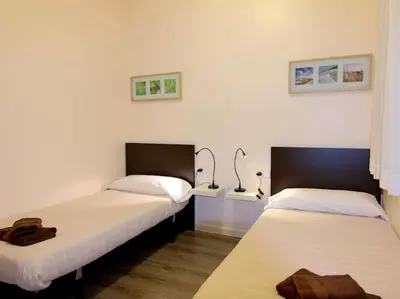 two beds sitting next to each other in a room at ClassBedroom Eixample Free Apartments in Barcelona