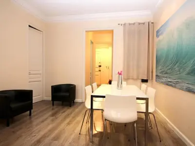 a dining room with a white table and chairs at ClassBedroom Eixample Free Apartments in Barcelona