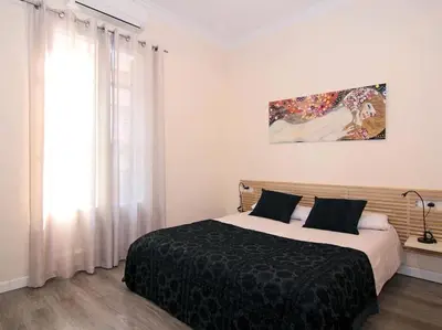 a bedroom with a large bed and a window at ClassBedroom Eixample Free Apartments in Barcelona