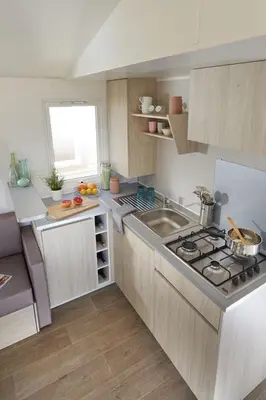a kitchen with a sink and a stove top oven at Camping Bellsol Pets in Pineda de Mar