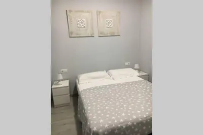 a bedroom with a bed and two pictures on the wall at sagrada familia gaudi in Barcelona
