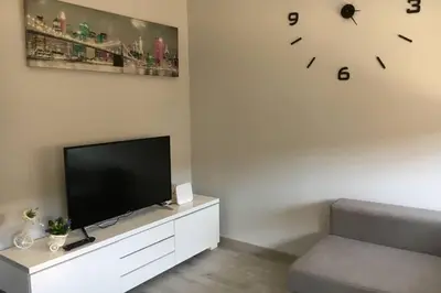 a living room with a television and a clock on the wall at sagrada familia gaudi in Barcelona