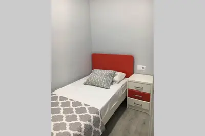a small bedroom with a bed and a nightstand at sagrada familia gaudi in Barcelona