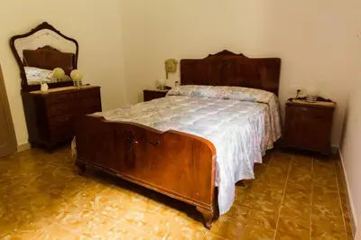 a bedroom with a bed and two dressers and a mirror at Masia Can Castanyola in Marganell