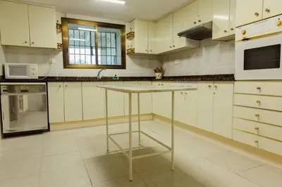 a kitchen with a table in the middle of it at Masia Can Castanyola in Marganell