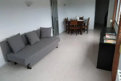 a living room with a gray couch and a table at Masia Can Castanyola in Marganell