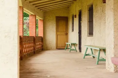 two green tables in a room with a door at Masia Can Castanyola in Marganell