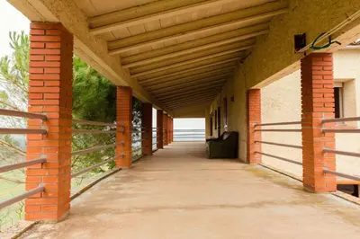 an empty hallway of a building with a wooden roof at Masia Can Castanyola in Marganell