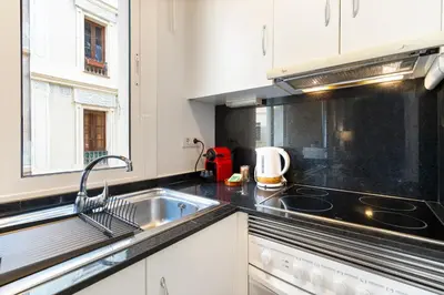 a kitchen with a sink and a stove at Lodging Apartments Beach Studio 11 in Barcelona