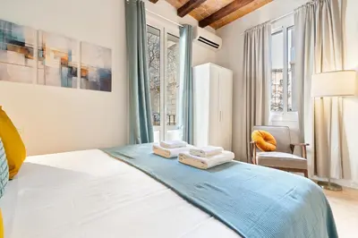 a bedroom with a bed with towels on it at Lodging Apartments Beach Studio 11 in Barcelona