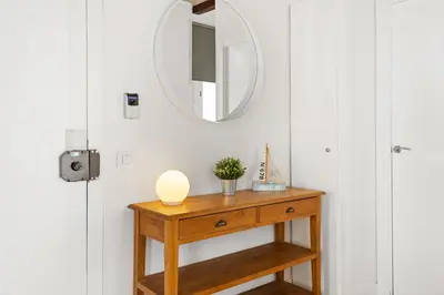 a dressing room with a wooden table and a mirror at Lodging Apartments Beach Studio 22 in Barcelona