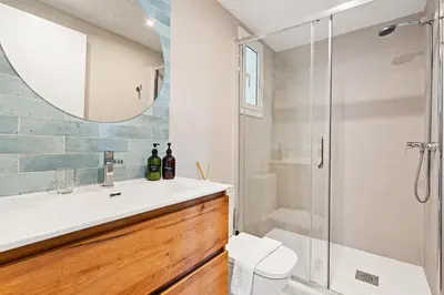 a bathroom with a sink and a shower at Lodging Apartments Beach Studio 22 in Barcelona