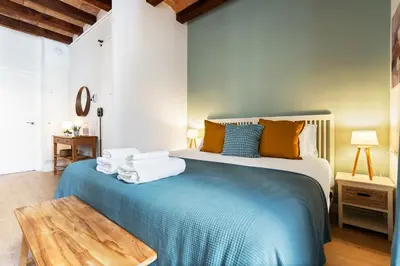 a bedroom with a bed with towels on it at Lodging Apartments Beach Studio P1 in Barcelona