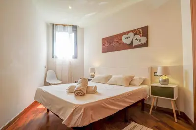 a bedroom with a bed with two pillows on it at Seaside April Apartment by Hello Homes Sitges in Sitges