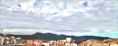 a view of a city under a cloudy sky at Hostal Isla Cristina Mataro in Mataró