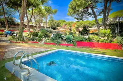a swimming pool in the backyard of a house at Villa Maresme & Villa Rosa in Mataró