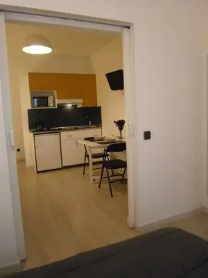 a room with a kitchen and a table with a table at Marbel Apartments in Barcelona