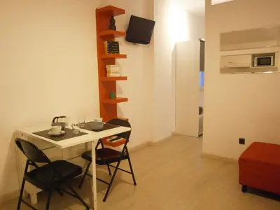 a room with a table and chairs in a room at Marbel Apartments in Barcelona