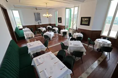 a dining room with white tables and green chairs at Hotel Montrubí 1771 - Slow Winery Hotel - Adults only in Font-Rubí