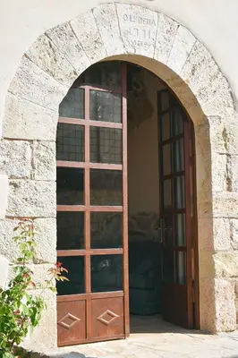 a door to a building with a stone archway at Hotel Montrubí 1771 - Slow Winery Hotel - Adults only in Font-Rubí