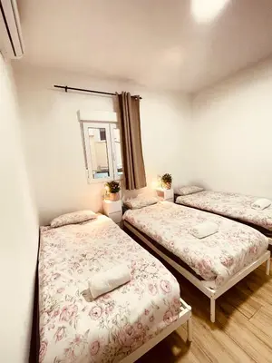 a bedroom with two beds and a mirror at Apartamentos Tarradellas Sants Estació in Barcelona
