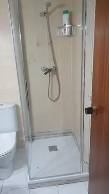 a shower with a glass door in a bathroom at APARTAMENTO CON OFICINA Y VISTAS AL MAR in Sitges