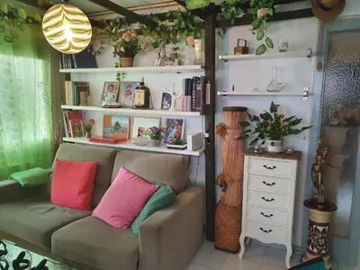a room with a couch with two pillows on it at APARTAMENTO CON OFICINA Y VISTAS AL MAR in Sitges