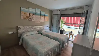 a hotel room with two beds and a window at Apto, Ático Airport BCN, Cruise Port, Near beaches in Viladecáns