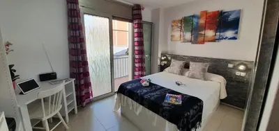 a small bedroom with a bed and a balcony at Apto, Ático Airport BCN, Cruise Port, Near beaches in Viladecáns