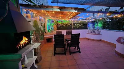 a patio with a table and chairs and a fireplace at Apto, Ático Airport BCN, Cruise Port, Near beaches in Viladecáns