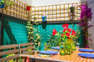 a table with plates and flowers on a patio at Apartamento Rosellón in Barcelona