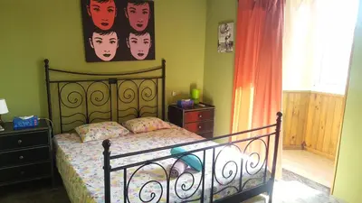 a bedroom with a bed and a painting on the wall at Apartamento Mediterraneo in Pineda de Mar