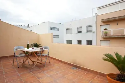 a patio with a table and chairs on a balcony at Homenfun Barcelona Montjuic in Barcelona