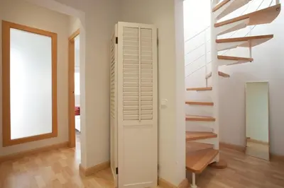 a hallway with a staircase in a house at Homenfun Barcelona Montjuic in Barcelona