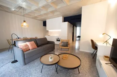 a living room with a couch and two tables at Barcelona Touch Apartments - Rosich in Hospitalet de Llobregat