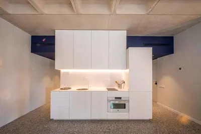 a kitchen with white cabinets and a sink at Barcelona Touch Apartments - Rosich in Hospitalet de Llobregat