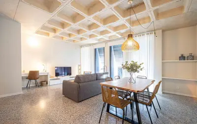 a living room with a table and a couch at Barcelona Touch Apartments - Rosich in Hospitalet de Llobregat