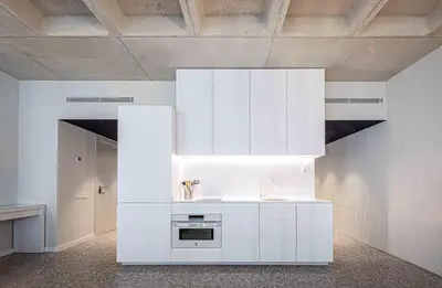 a kitchen with white cabinets and a sink at Barcelona Touch Apartments - Rosich in Hospitalet de Llobregat