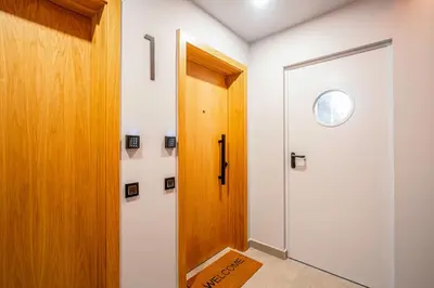 a hallway with a door and a window at ApartsNouBcn Equador Les Corts in Barcelona