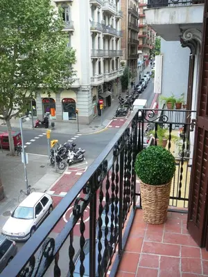 a balcony with a view of a city street with motorcycles at Mirall Sant Gervasi in Barcelona