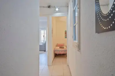 a hallway leading to a room with a bed at Mirall Sant Gervasi in Barcelona